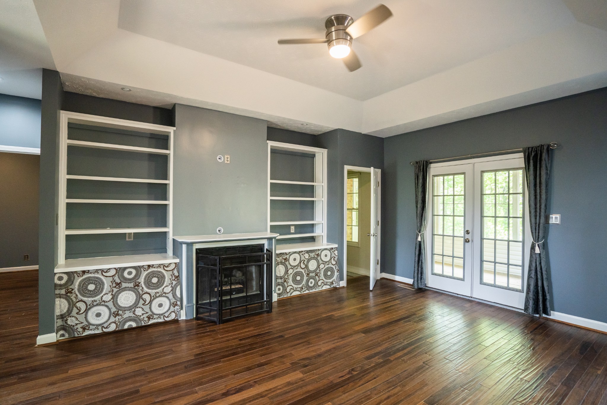 3077 Old Clarksville Sprgfld Road Adams, TN 37010 - Photo 8 of 33 a view of a livingroom with wooden floor a ceiling fan and windows