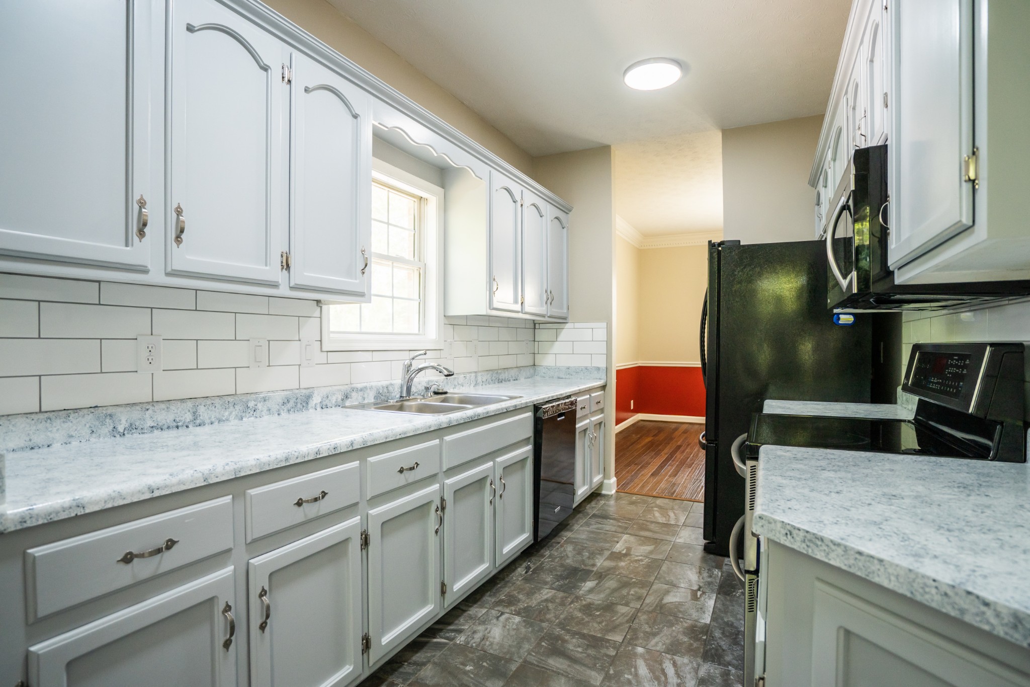 3077 Old Clarksville Sprgfld Road Adams, TN 37010 - Photo 10 of 33 a kitchen with granite countertop a sink stainless steel appliances and cabinets