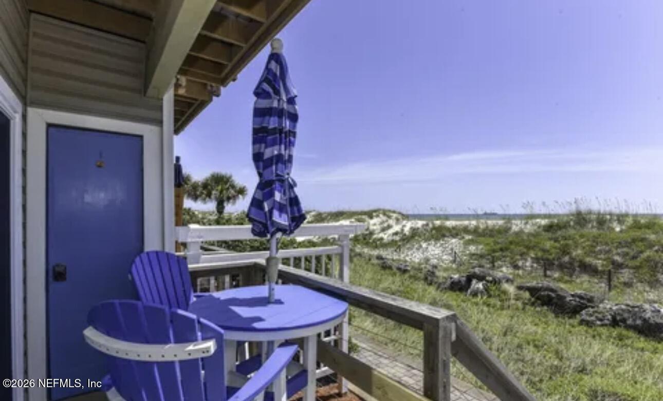 2 10th Street, Unit 2 St. Augustine Beach, FL 32080 - Photo 1 of 55 a view of a balcony with furniture and a potted plant