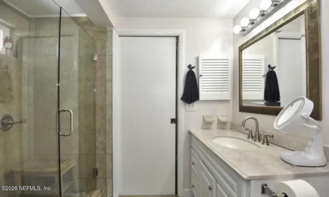 2 10th Street, Unit 2 St. Augustine Beach, FL 32080 - Photo 17 of 55 a bathroom with a granite countertop sink and a mirror