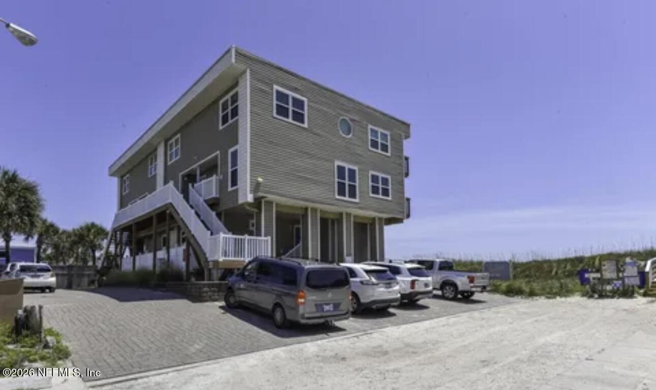 2 10th Street, Unit 2 St. Augustine Beach, FL 32080 - Photo 38 of 55 a front view of a building with cars parked