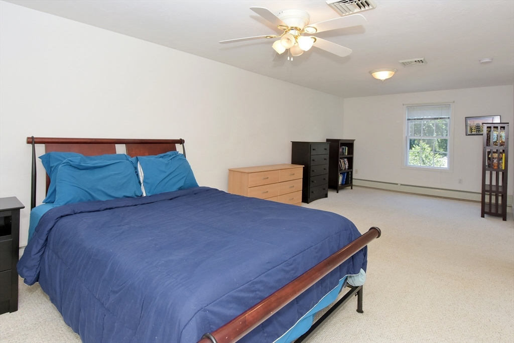 16 Sherwood Road Worcester, MA 01602 - Photo 15 of 30 a bedroom with a bed and a chandelier