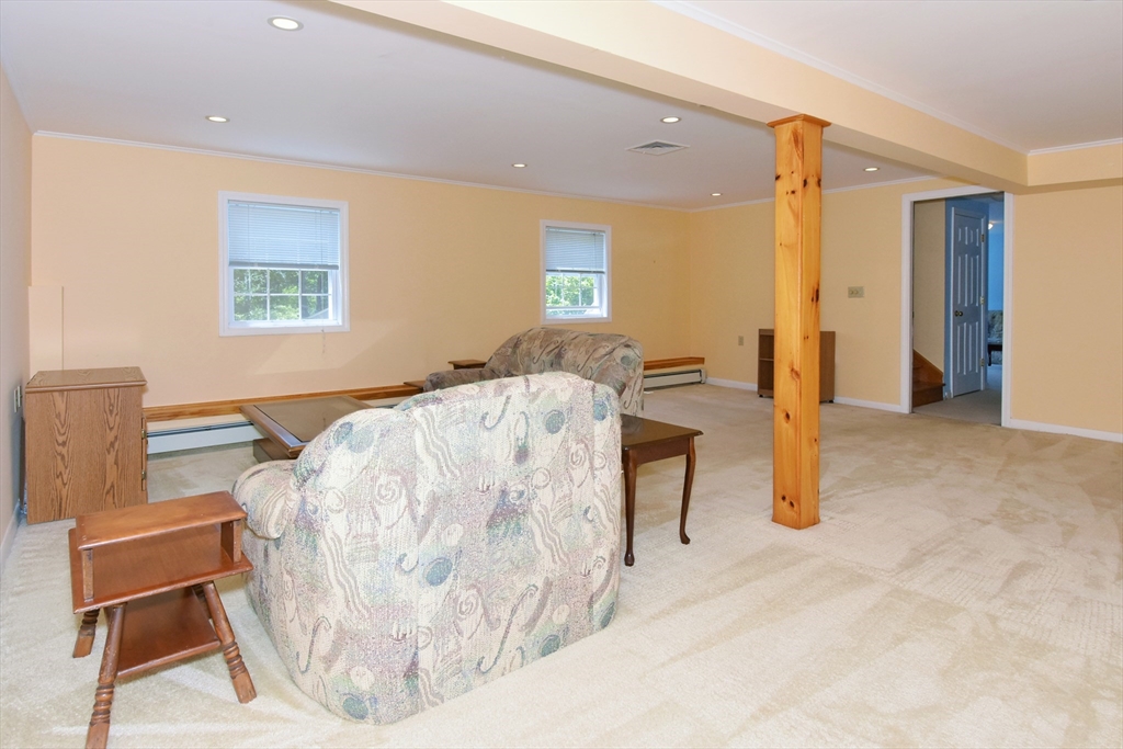 16 Sherwood Road Worcester, MA 01602 - Photo 26 of 30 a bedroom with a bed and a chair