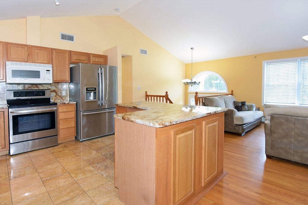 16 Sherwood Road Worcester, MA 01602 - Photo 3 of 30 a kitchen with stainless steel appliances granite countertop a sink a stove and a refrigerator