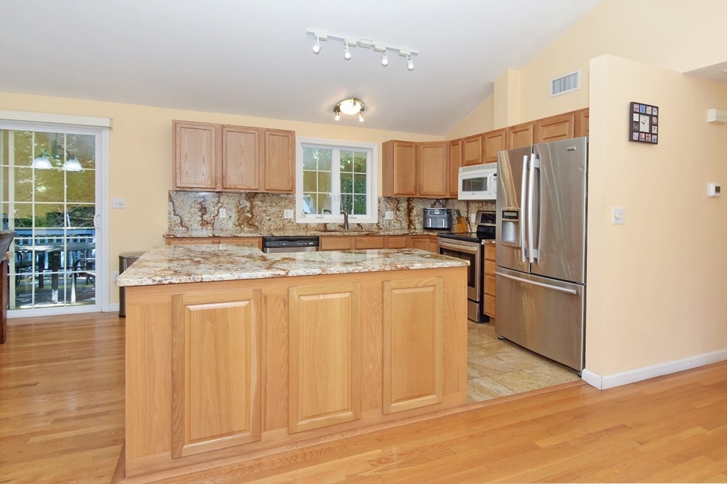 16 Sherwood Road Worcester, MA 01602 - Photo 5 of 30 a kitchen with stainless steel appliances granite countertop a refrigerator a stove a sink and a granite counter tops with white cabinets