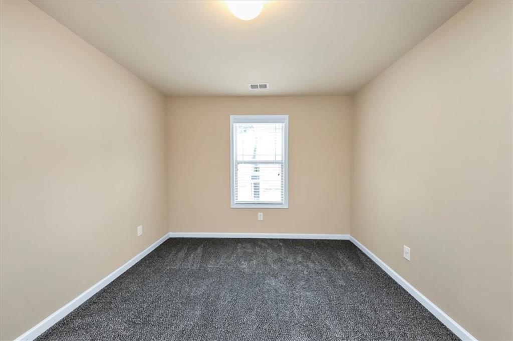 182 Townview Drive Woodstock, GA 30189 - Photo 17 of 37 an empty room with a window
