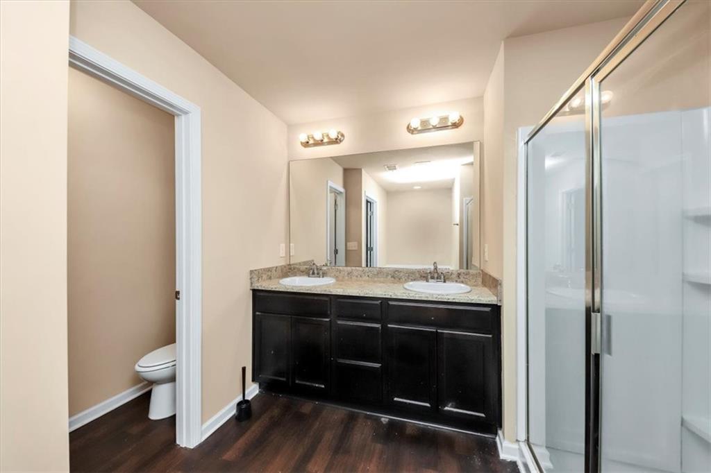 182 Townview Drive Woodstock, GA 30189 - Photo 30 of 37 a bathroom with a toilet a sink and mirror