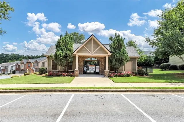 a view of a house with swimming pool and sitting area