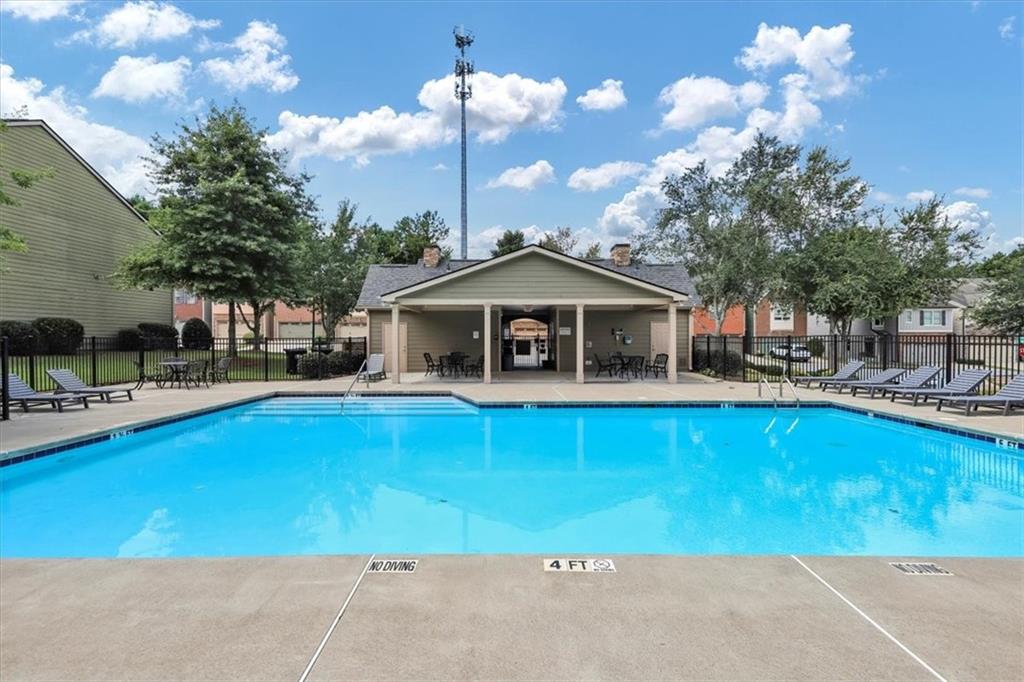 182 Townview Drive Woodstock, GA 30189 - Photo 36 of 37 a front view of house with yard and swimming pool