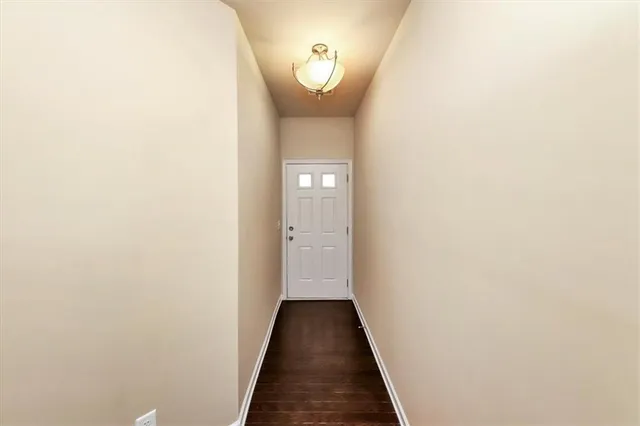 a view of a kitchen from the hallway