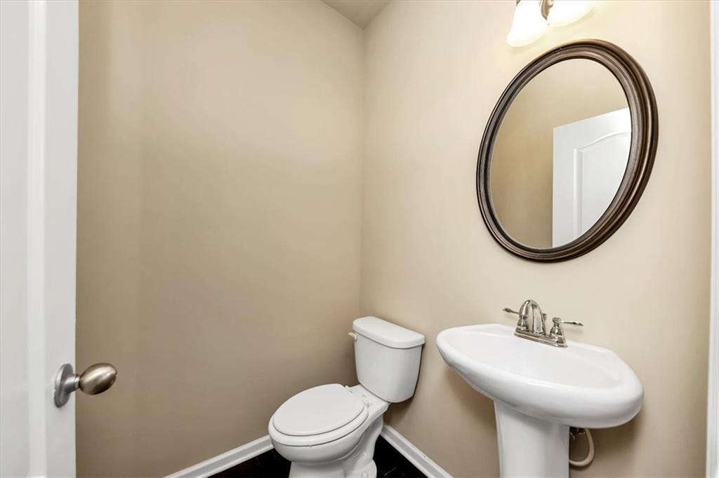 182 Townview Drive Woodstock, GA 30189 - Photo 6 of 37 a white toilet sitting next to a bathroom sink