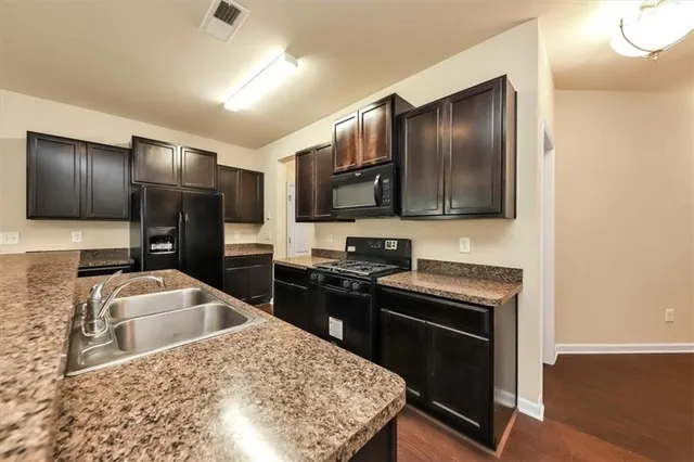 a kitchen with stainless steel appliances granite countertop counter space and cabinets