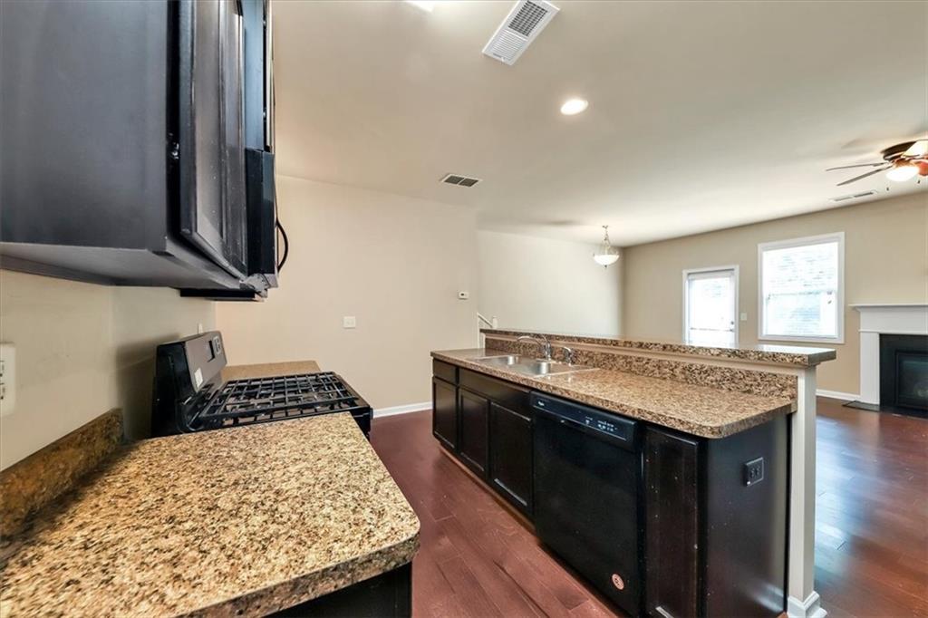 182 Townview Drive Woodstock, GA 30189 - Photo 10 of 37 a kitchen with a stove and a wooden floor