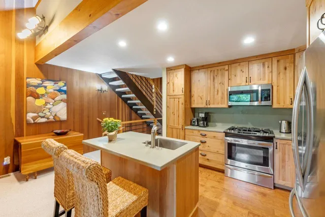 a kitchen with a sink appliances and cabinets