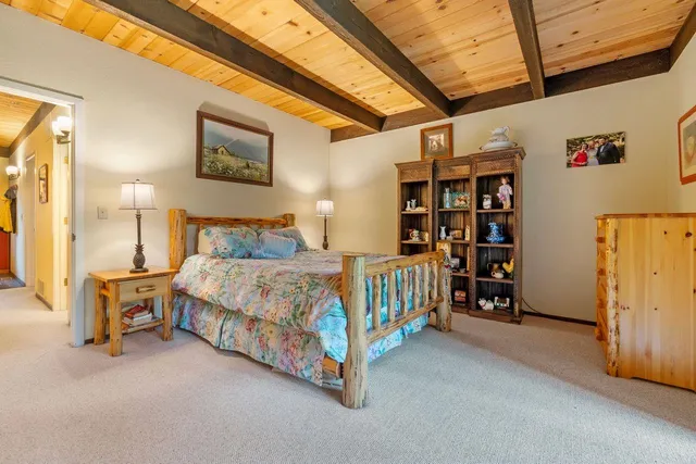 a bedroom with a bed next to a window