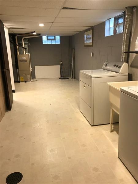 317 West Bruceton Road Pittsburgh, PA 15236 - Photo 20 of 22 Large laundry room with vinyl flooring and plenty of space for storage.