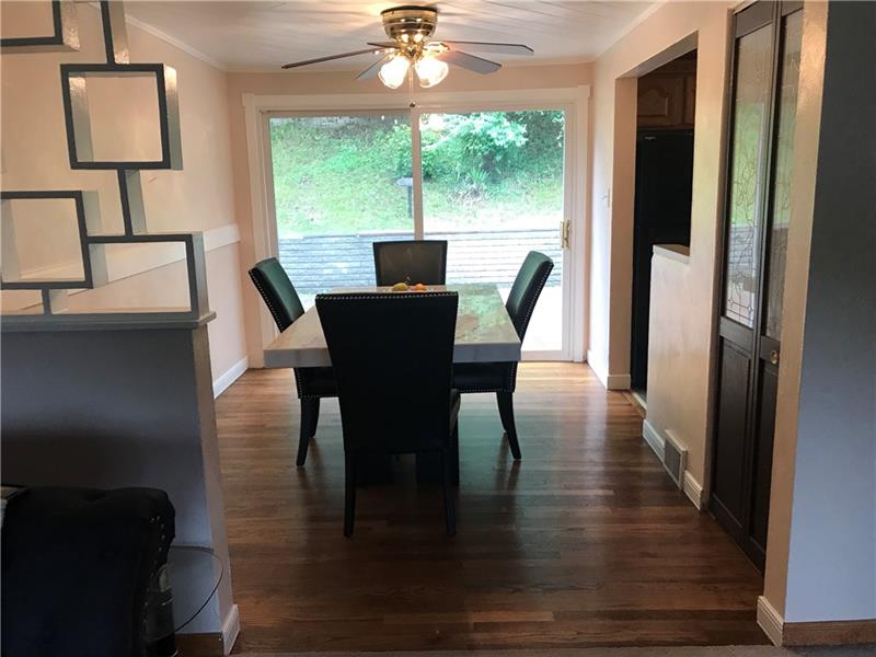317 West Bruceton Road Pittsburgh, PA 15236 - Photo 6 of 22 Gorgeous hardwood floor enhance the large dining room with a view to rear deck from the oversized sliding glass door. Decorative door on right of picture leads to the upstairs.
