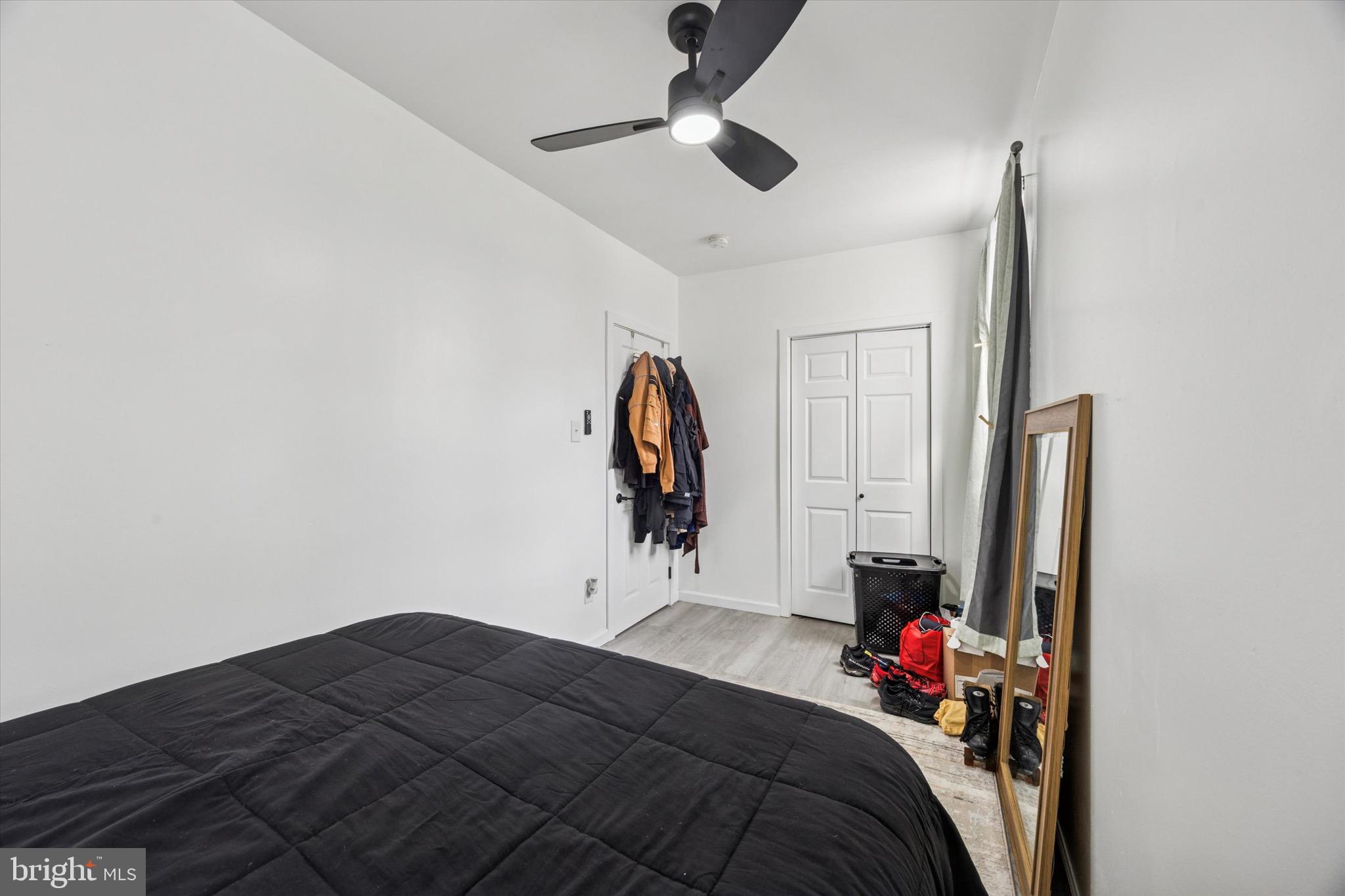 6153 Locust Street, Unit 1 Philadelphia, PA 19139 - Photo 8 of 14 a bedroom with a bed and a chandelier