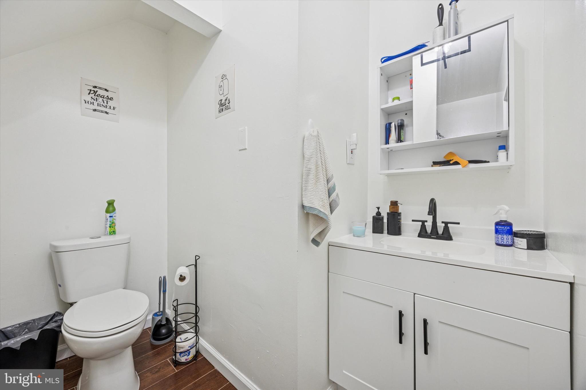 6153 Locust Street, Unit 1 Philadelphia, PA 19139 - Photo 10 of 14 a bathroom with a sink a toilet and vanity