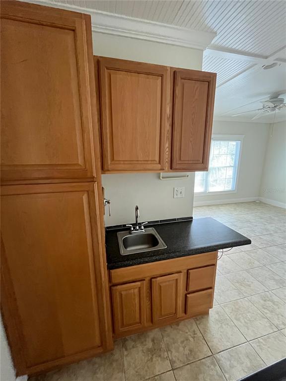 3222 Hammersmith Road Orlando, FL 32818 - Photo 14 of 29 a kitchen with a sink and a refrigerator