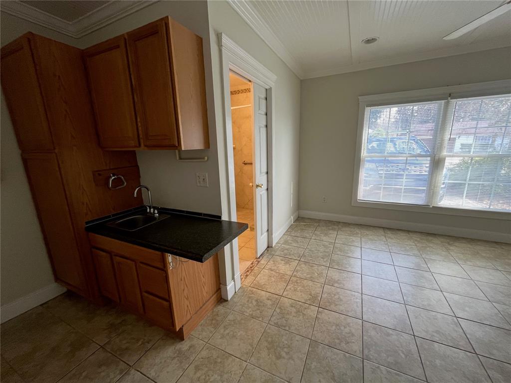 3222 Hammersmith Road Orlando, FL 32818 - Photo 15 of 29 a kitchen with granite countertop a stove a sink and a refrigerator
