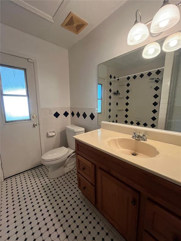 3222 Hammersmith Road Orlando, FL 32818 - Photo 26 of 29 a bathroom with a sink mirror and toilet