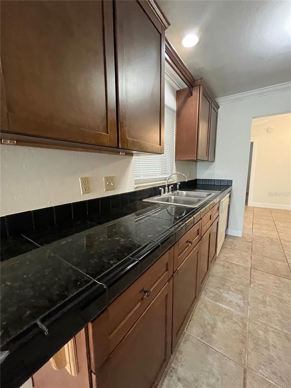 3222 Hammersmith Road Orlando, FL 32818 - Photo 8 of 29 a kitchen with stainless steel appliances a sink stove and cabinets