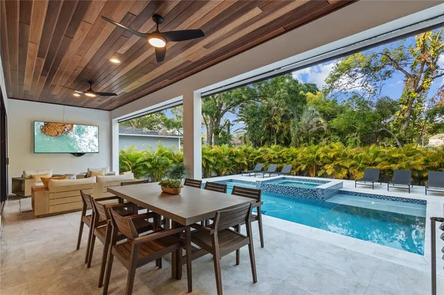 a view of a dining room with furniture large windows and wooden floor