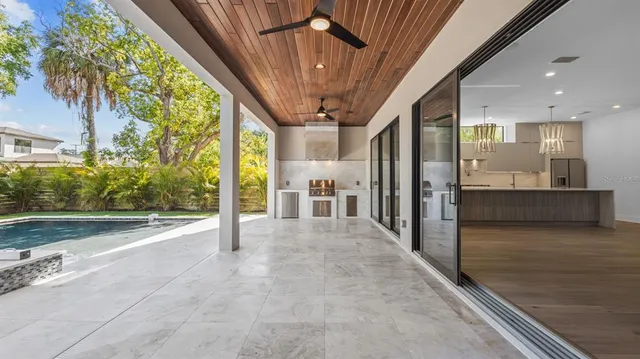 a view of a porch with furniture and a yard