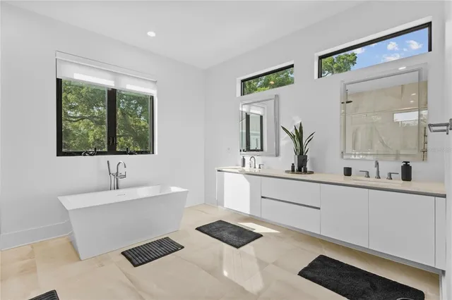 a bathroom with a bathtub sink and mirror