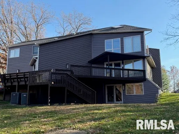 a kitchen with stainless steel appliances granite countertop wooden cabinets a granite counter and a sink