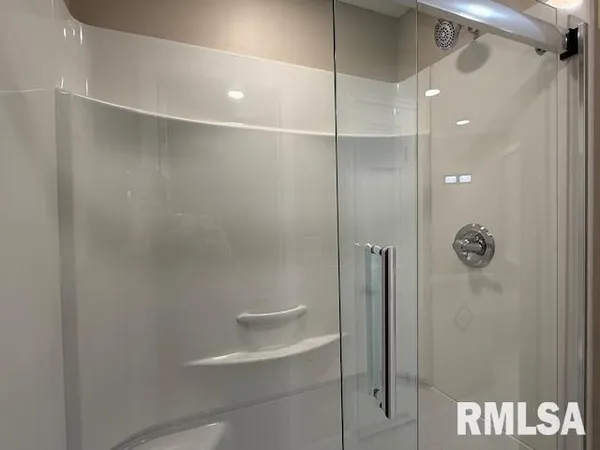 a bathroom with a shower sink and mirror