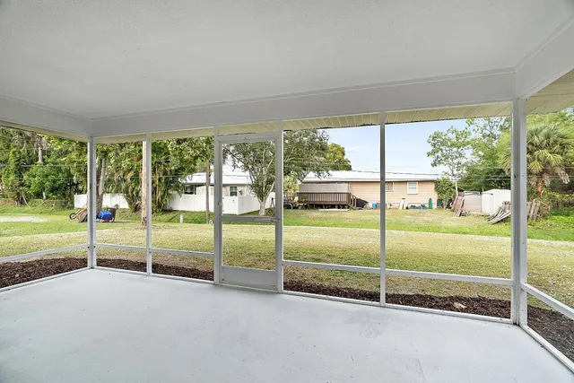 a view of a big room with floor to ceiling windows and city view
