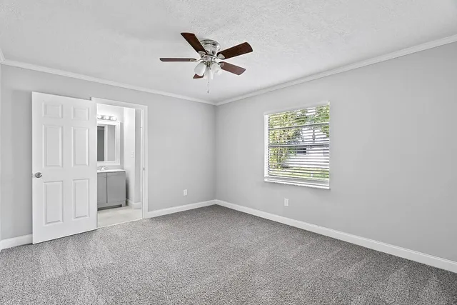 a view of a livingroom with a ceiling fan and window
