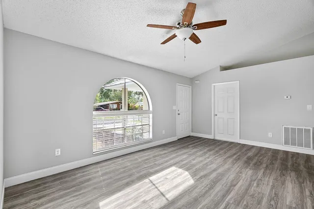 wooden floor in an empty room with a window