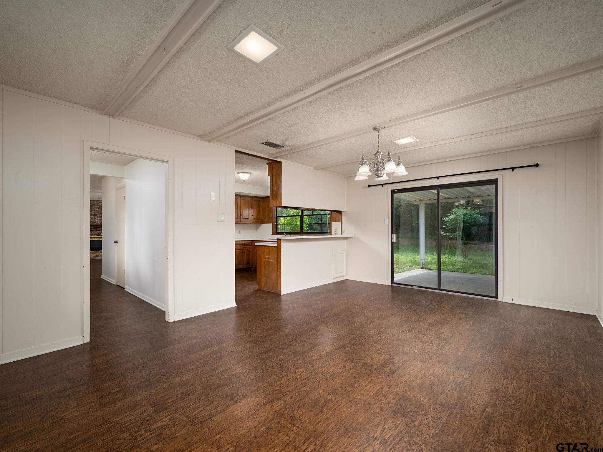 2513 Merry Lane Tyler, TX 75701 - Photo 11 of 26 a view of a big room with wooden floor and a kitchen