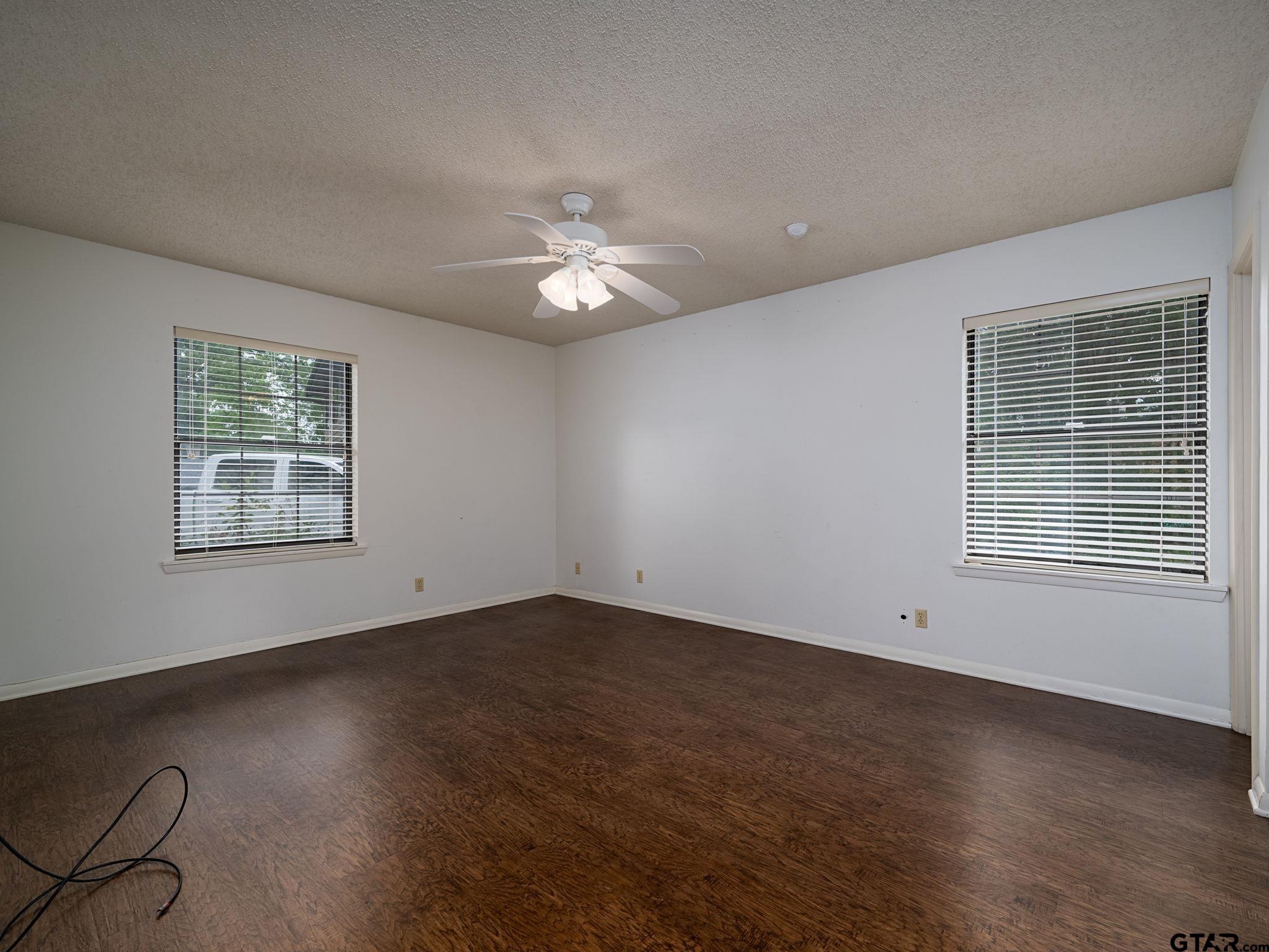 2513 Merry Lane Tyler, TX 75701 - Photo 13 of 26 a view of empty room with wooden floor and fan