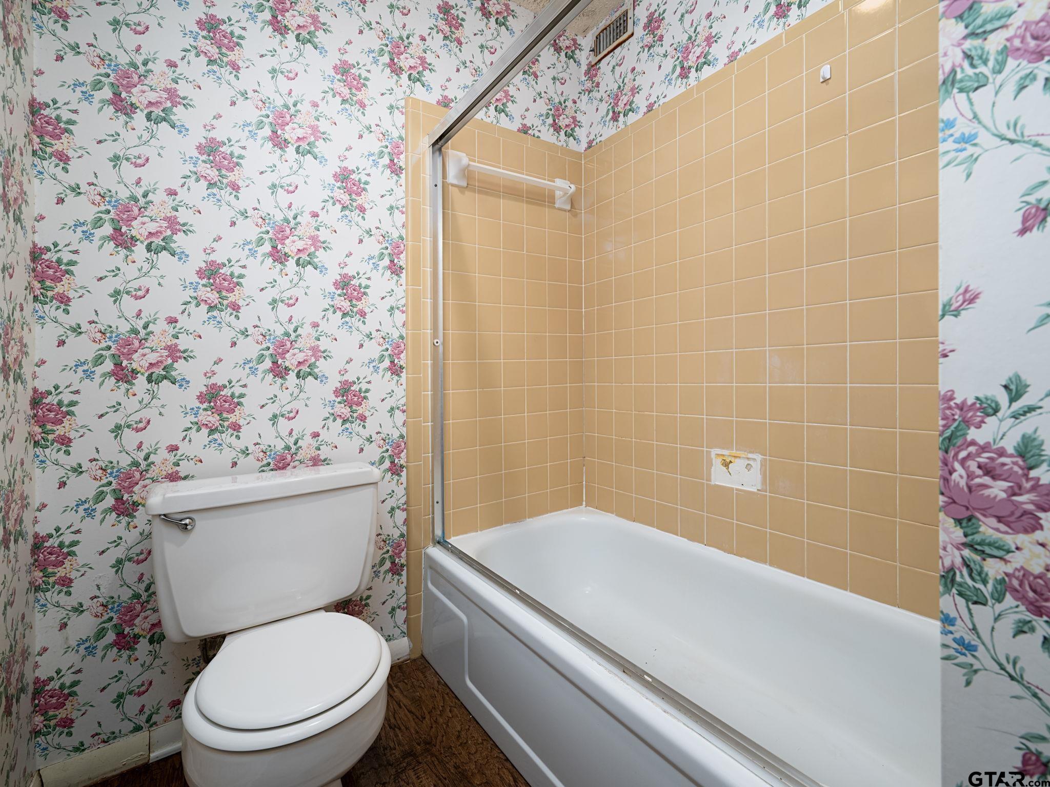 2513 Merry Lane Tyler, TX 75701 - Photo 15 of 26 a bathroom with a toilet and a shower curtain