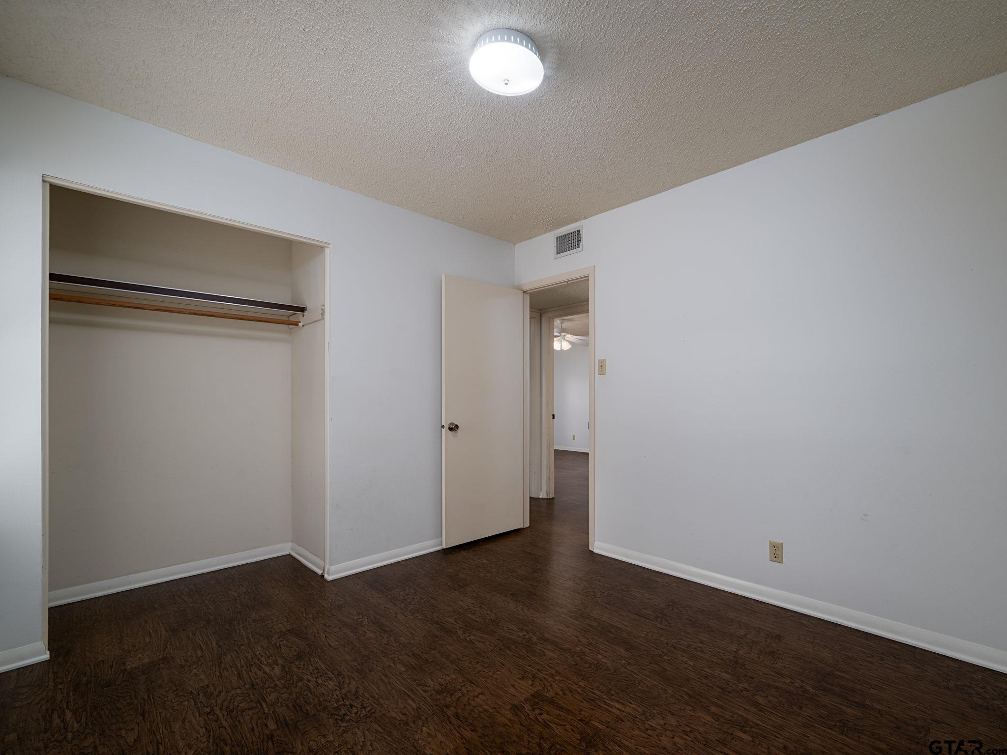 2513 Merry Lane Tyler, TX 75701 - Photo 17 of 26 a view of an empty room with wooden floor and closet