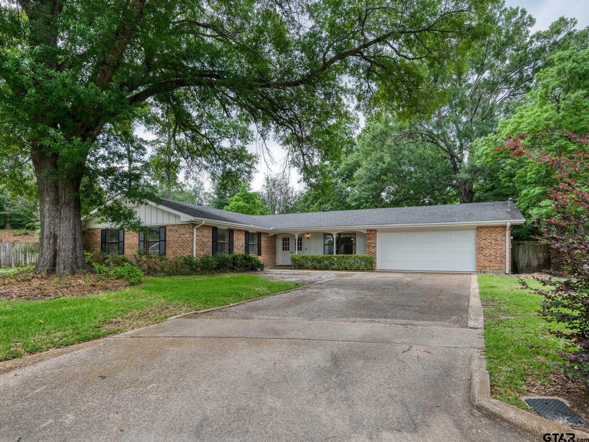 2513 Merry Lane Tyler, TX 75701 - Photo 2 of 26 front view of house with a yard and trees all around