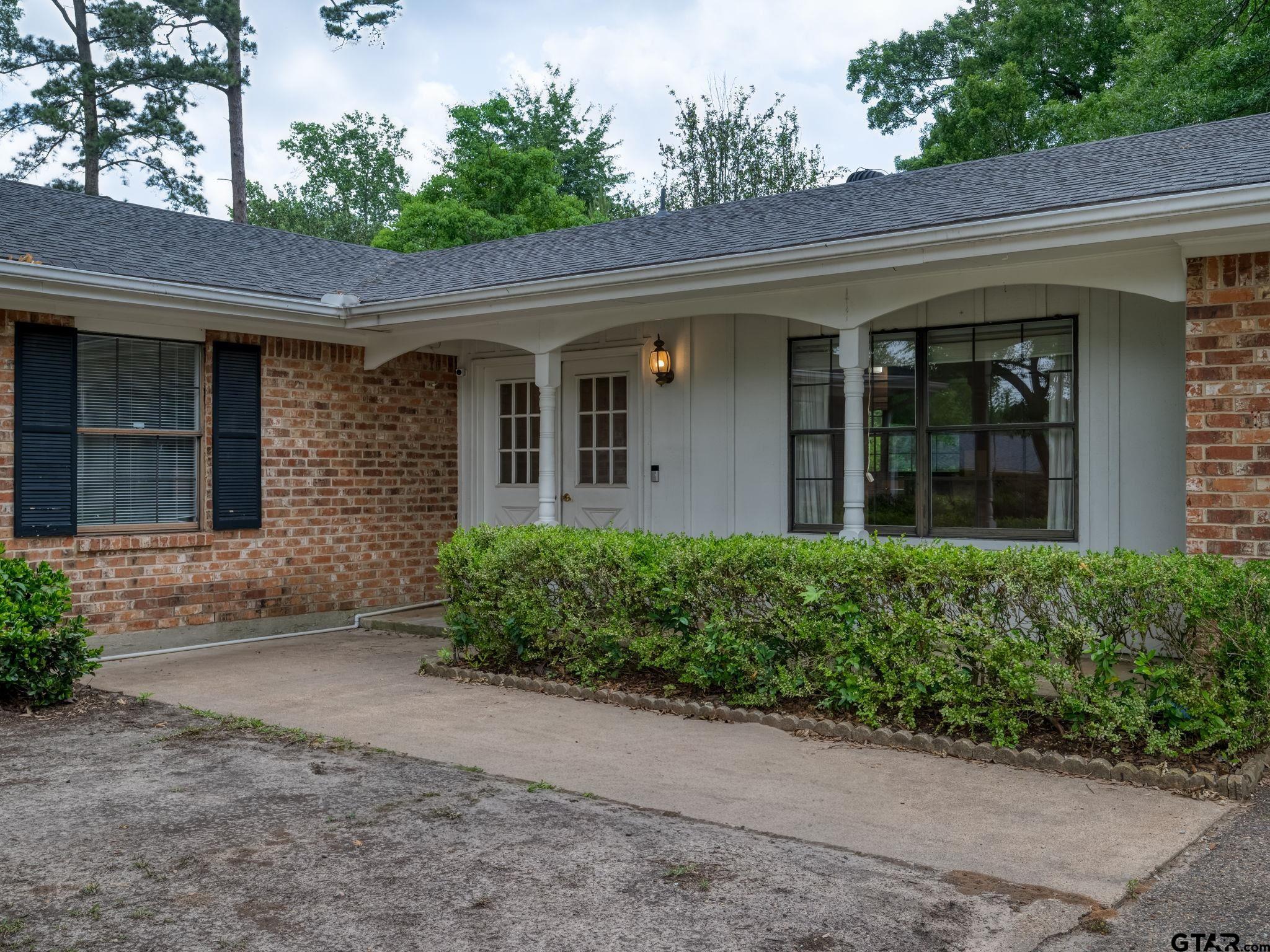 2513 Merry Lane Tyler, TX 75701 - Photo 4 of 26 front view of a brick house with a large window