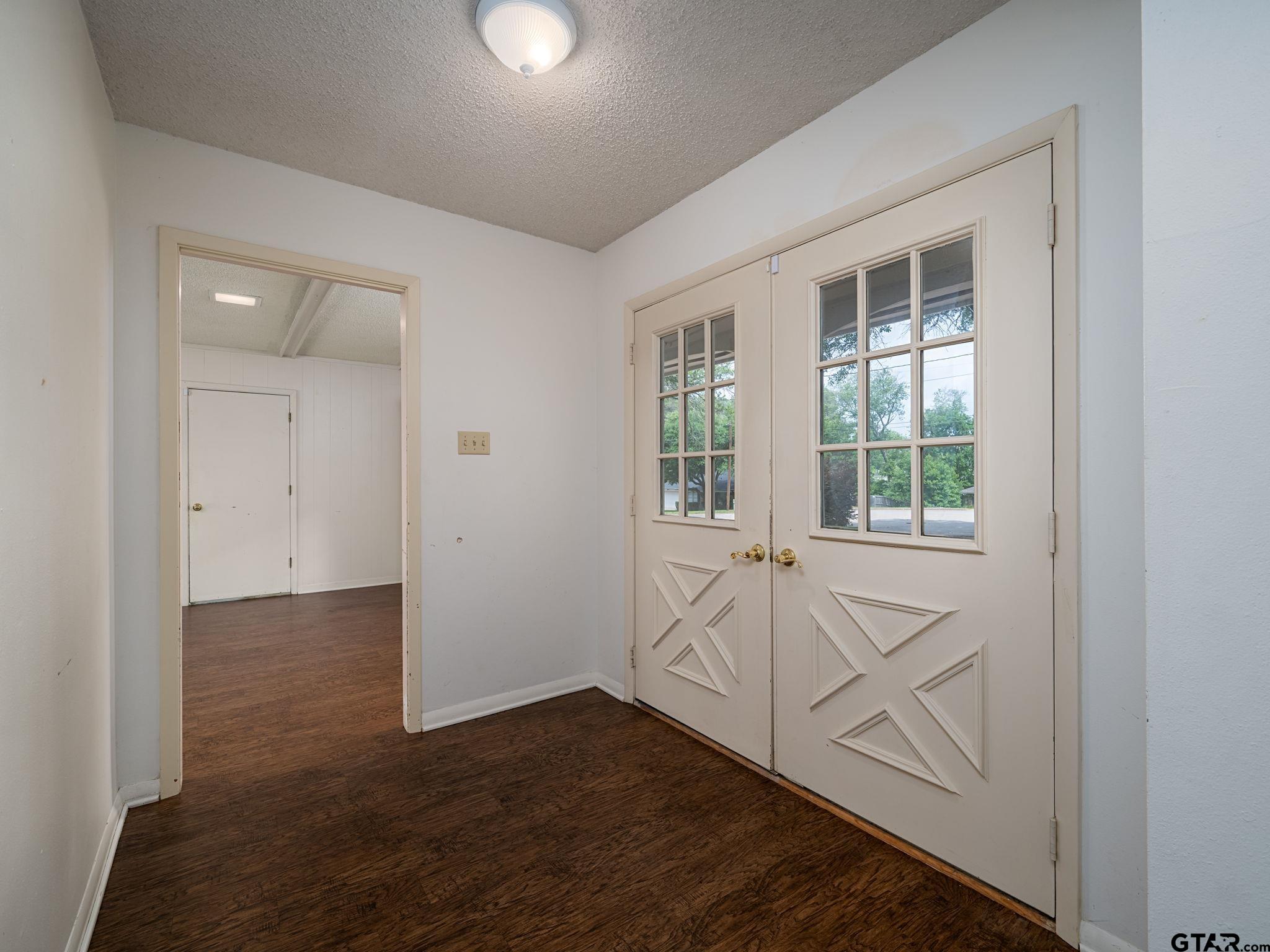 2513 Merry Lane Tyler, TX 75701 - Photo 5 of 26 an empty room with wooden floor and windows