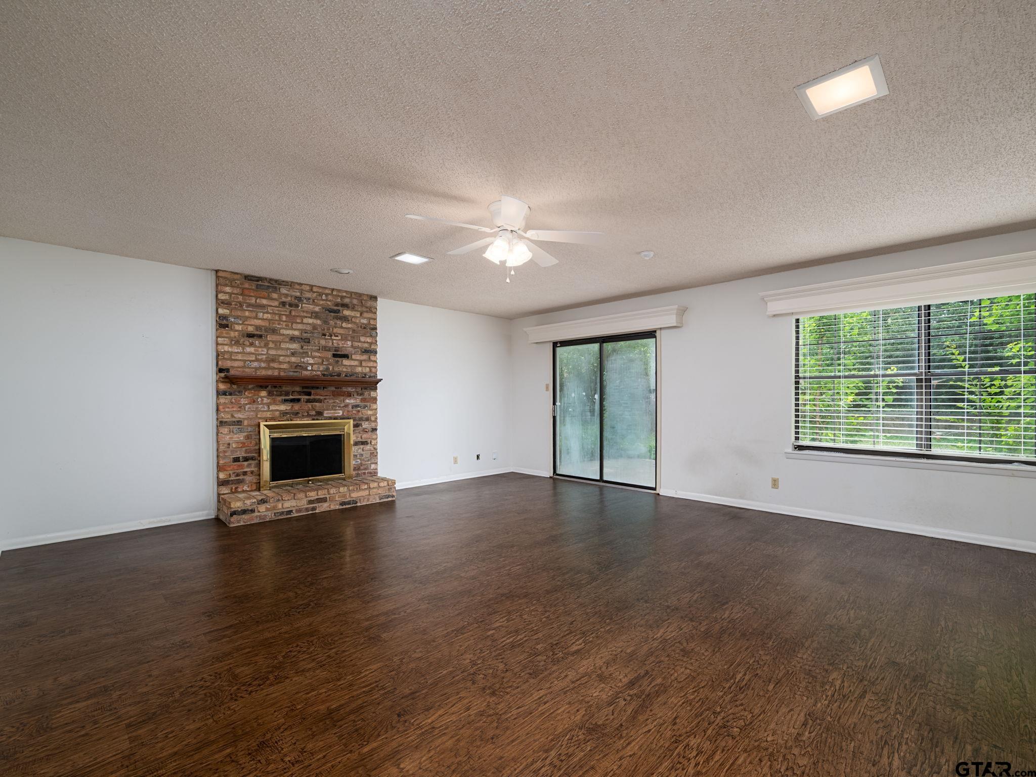 2513 Merry Lane Tyler, TX 75701 - Photo 6 of 26 a view of empty room with wooden floor and fireplace