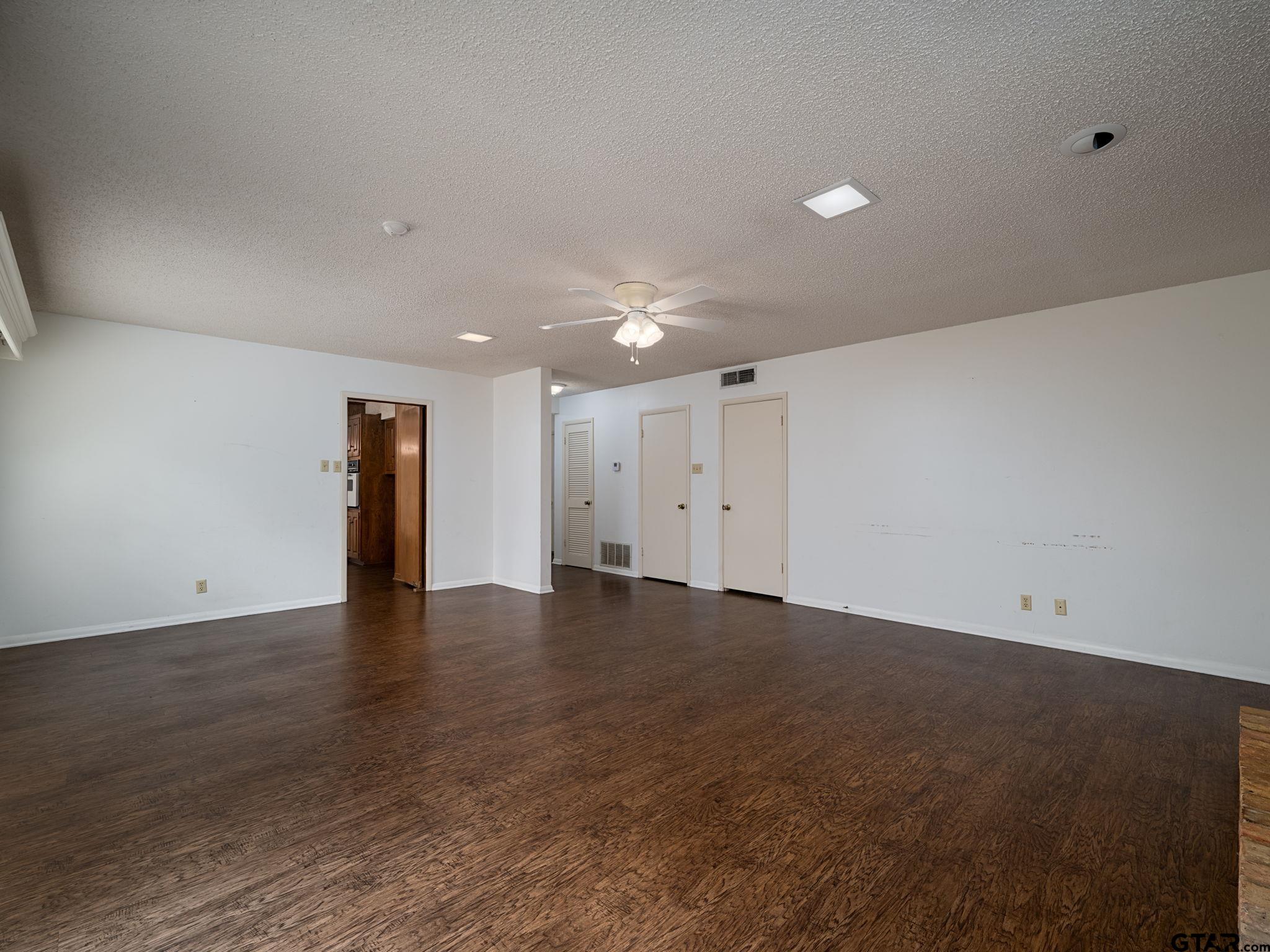 2513 Merry Lane Tyler, TX 75701 - Photo 7 of 26 a view of an empty room with wooden floor