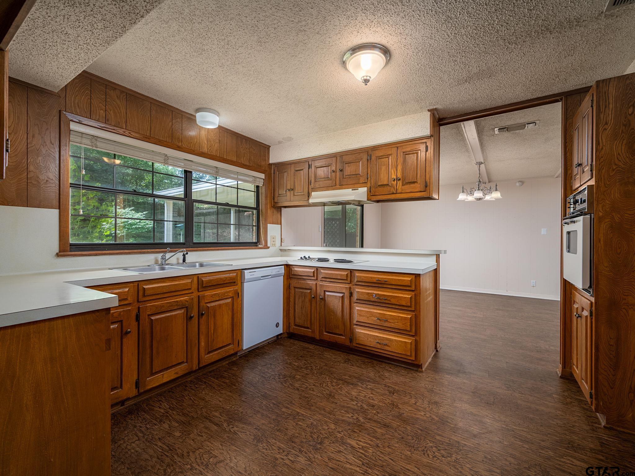 2513 Merry Lane Tyler, TX 75701 - Photo 9 of 26 a kitchen with stainless steel appliances granite countertop a stove and a refrigerator
