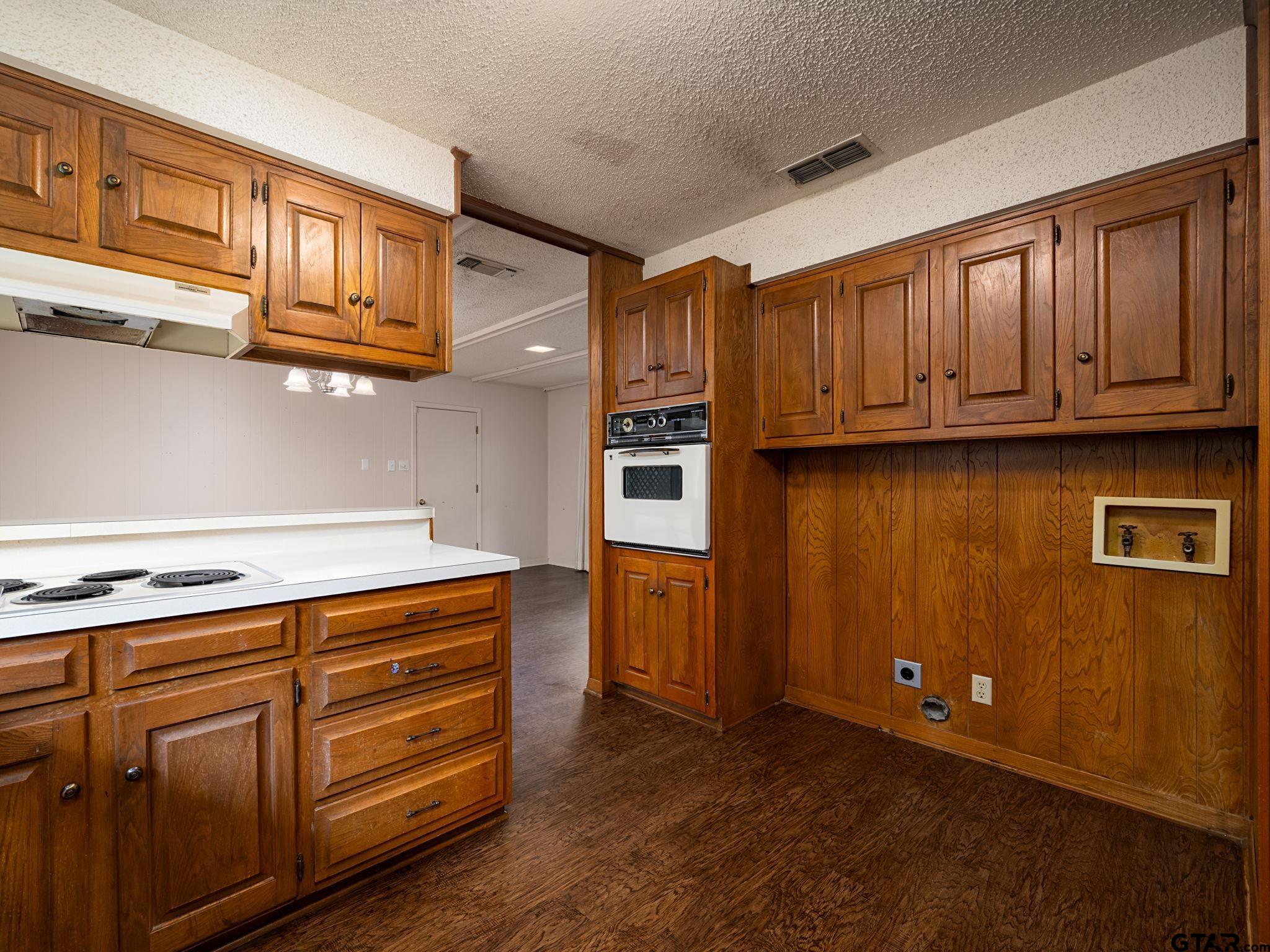 2513 Merry Lane Tyler, TX 75701 - Photo 10 of 26 a kitchen with stainless steel appliances granite countertop a refrigerator stove and wooden cabinets