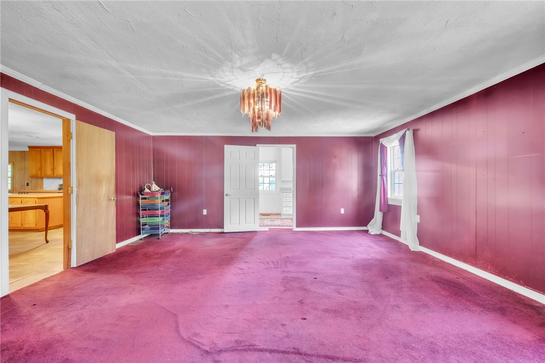 602 Harper Road Pendleton, SC 29670 - Photo 12 of 32 A well-lit living area offers ample space for relaxation and entertaining, adorned with a captivating chandelier.