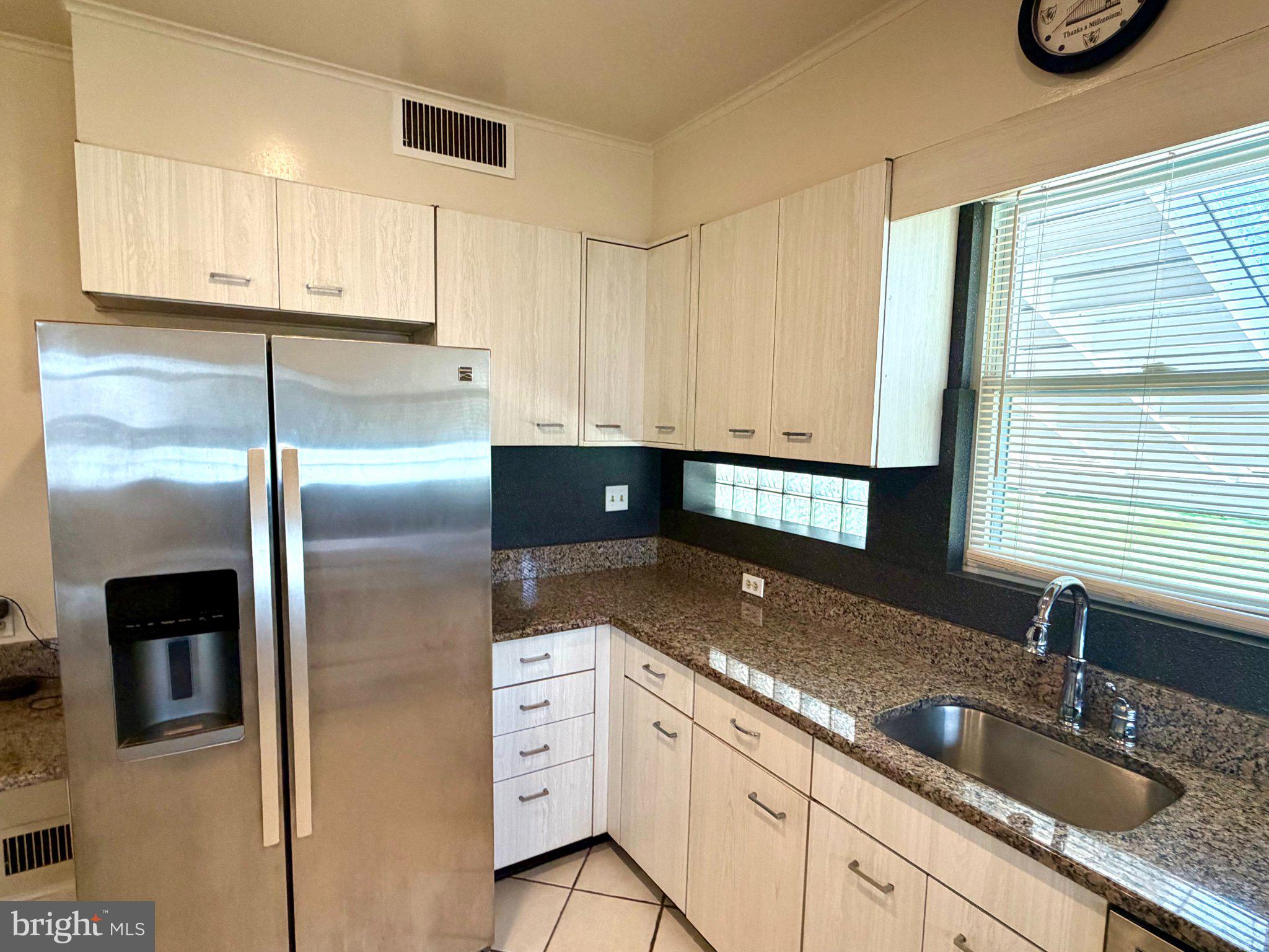 6318 Winner Avenue Baltimore, MD 21215 - Photo 23 of 75 a kitchen with granite countertop a sink stainless steel appliances and cabinets