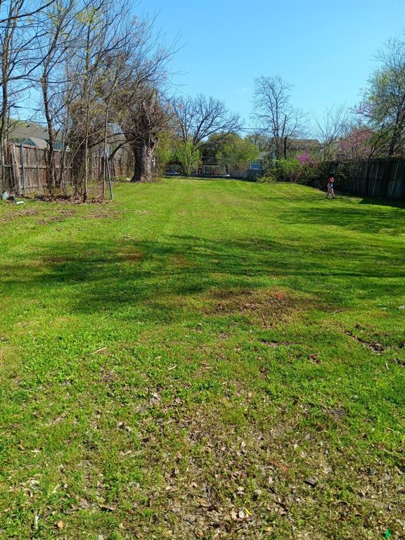 View of yard featuring fence