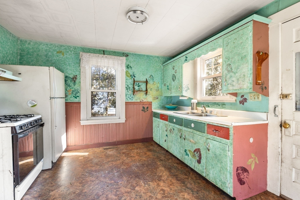 28 Birch Road Natick, MA 01760 - Photo 8 of 19 a kitchen with a stove a sink and a refrigerator
